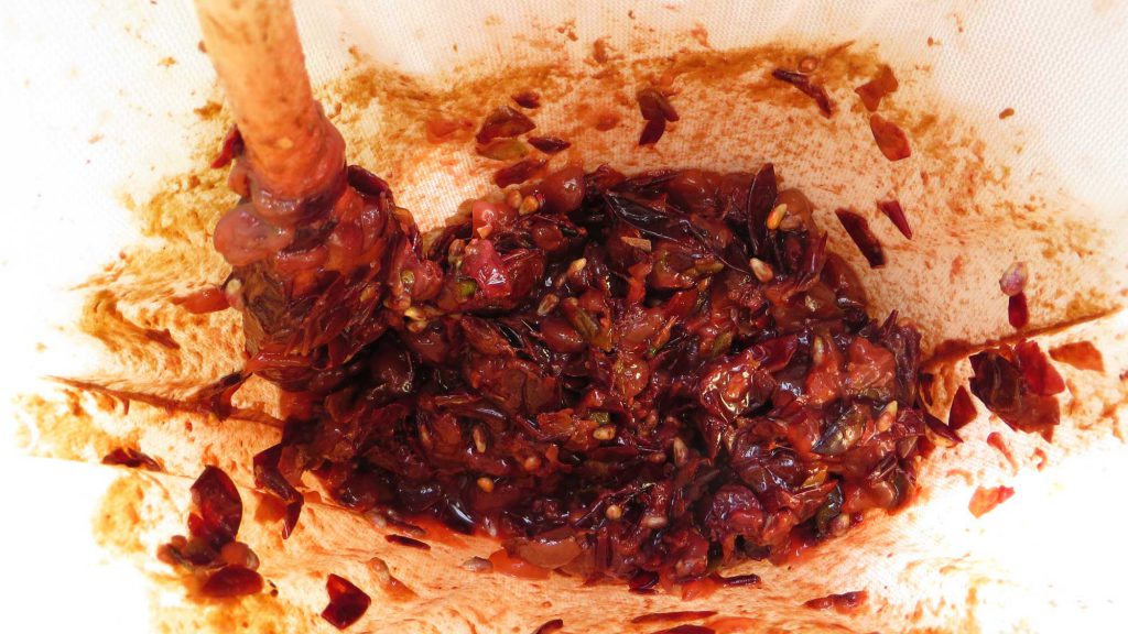 Straining crushed grapes through cheese cloth